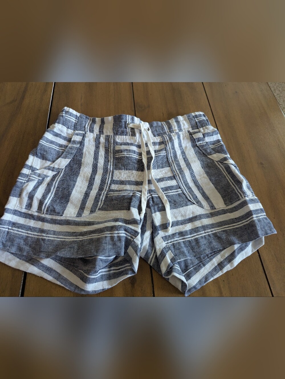 Athleta linen shorts featuring a navy blue and white striped pattern, an elastic